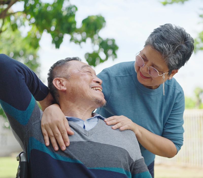 two adults embracing in a hug outside